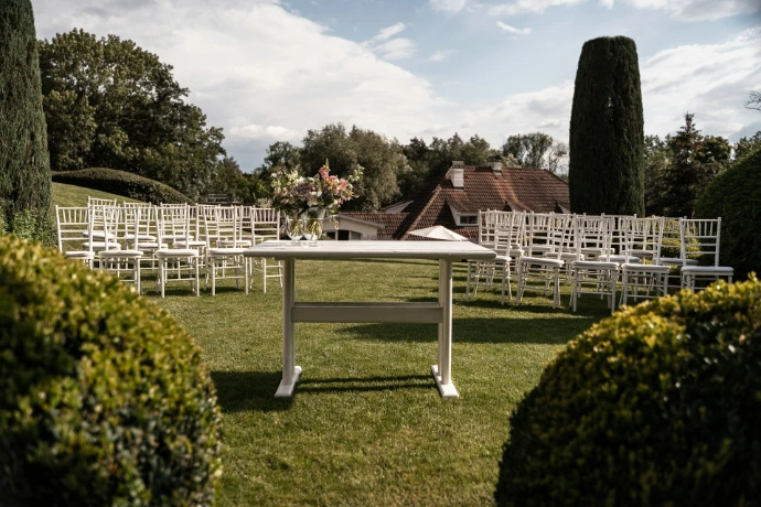 a table and chairs set up for a wedding ceremony